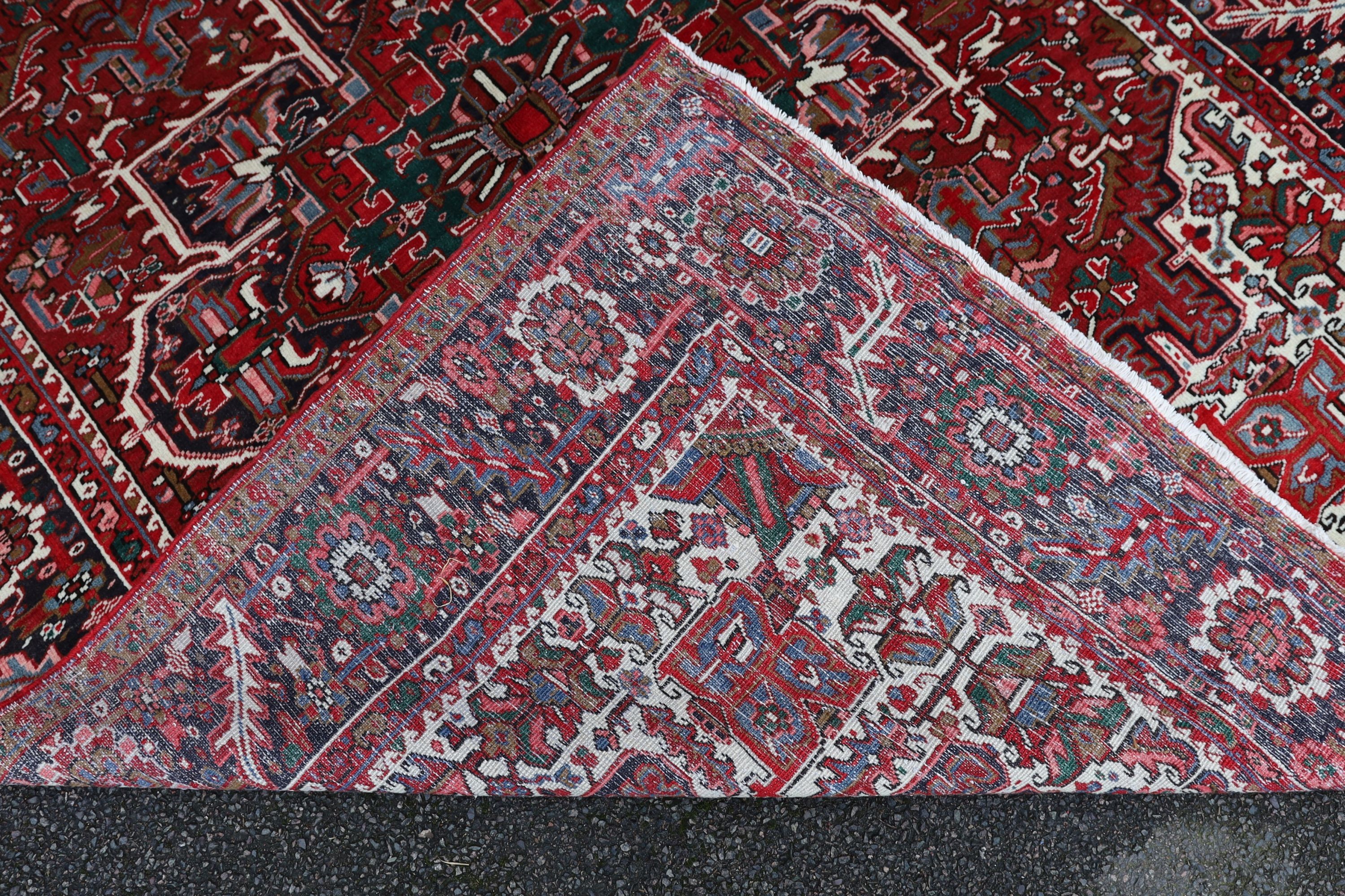 A Heriz red ground carpet, 324 x 243cm.